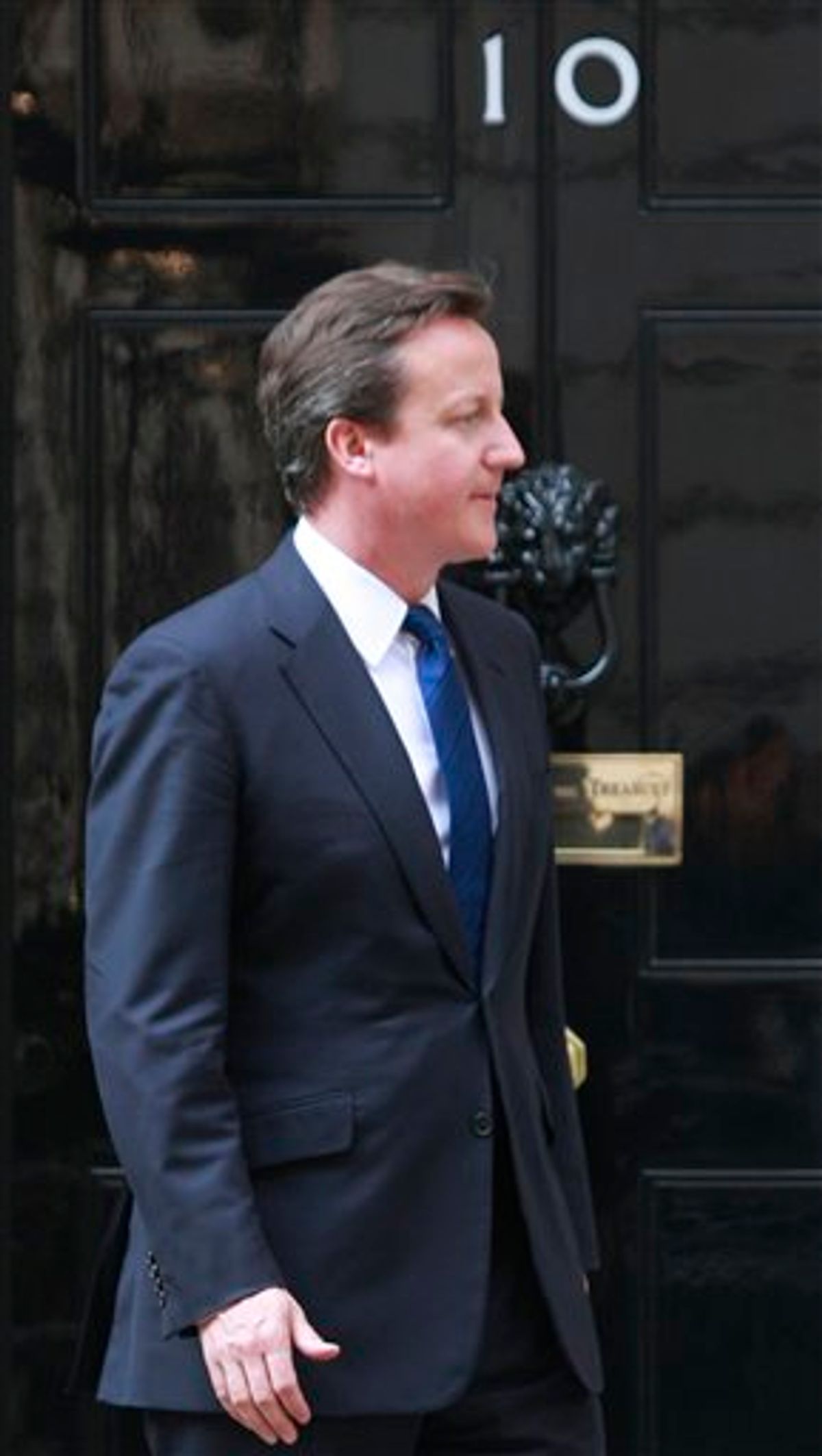 Britain's Prime Minister David Cameron, exits his official residence at 10 Downing Street in London, prior to a meeting, Monday, April 18, 2011. Cameron won't be wearing a formal morning suit with long tails to the royal wedding. Officials said Monday April 18, 2011, that the prime minister will wear a business suit to the April 29 wedding of Prince William and Kate Middleton. The invitation gives men a choice between suits, military uniforms, or traditional formal wear, which includes a long coat with tails. Religious leaders are allowed to wear their clerical outfits.(AP Photo/Lefteris Pitarakis)    (AP)