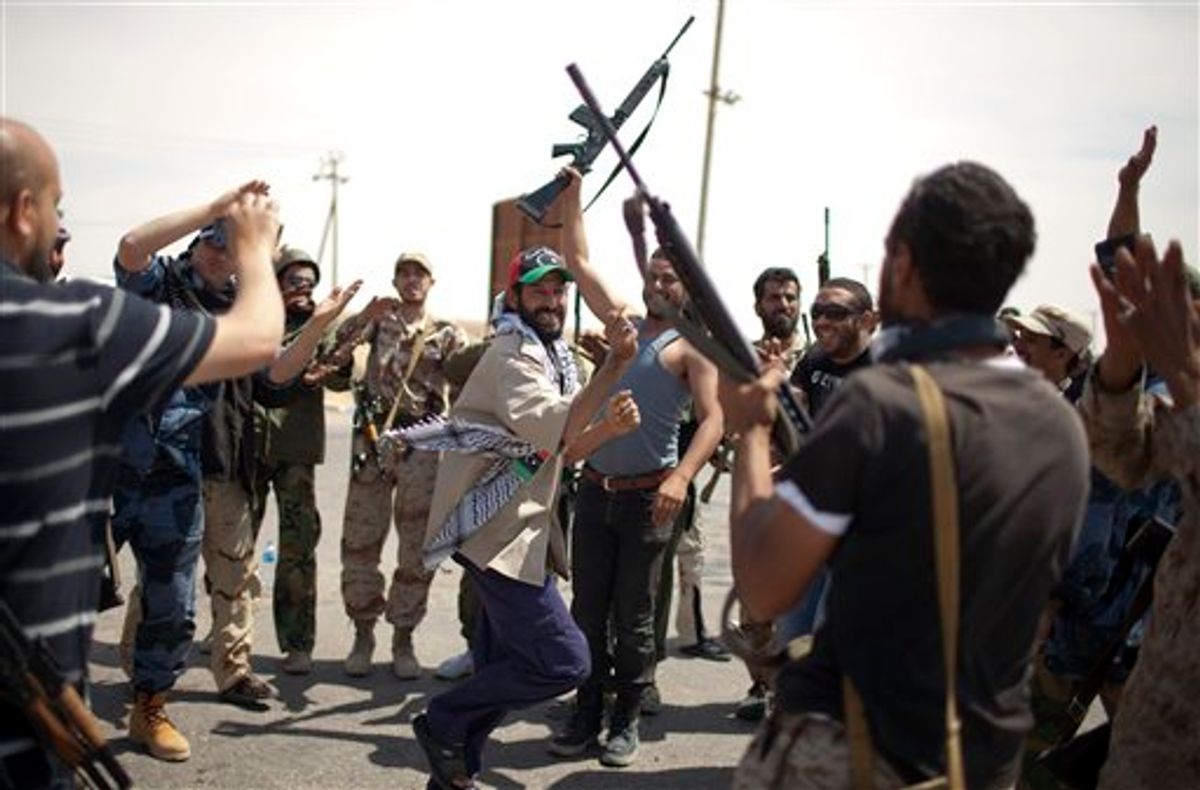 Rebel fighters dance in a check point in Ajdabia, Libya, Monday, May 9, 2011.  (AP Photo/Rodrigo Abd) (AP)