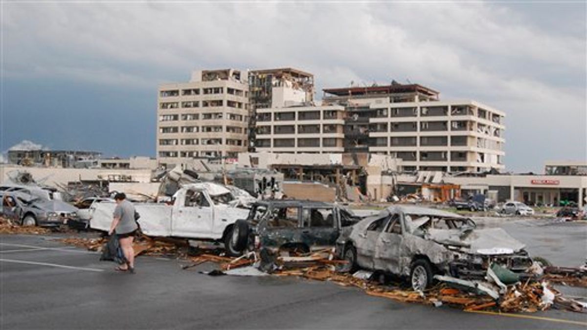 Damaged vehicles litter the parking lot of St. John's Hospital in Joplin, Mo, after a tornado hit the southwest Missouri city on Sunday evening, May 22, 2011. A massive tornado blasted its way across southwestern Missouri on Sunday, flattening several blocks of homes and businesses in Joplin and leaving residents frantically scrambling through the wreckage. (AP Photo/Mike Gullett) (AP)