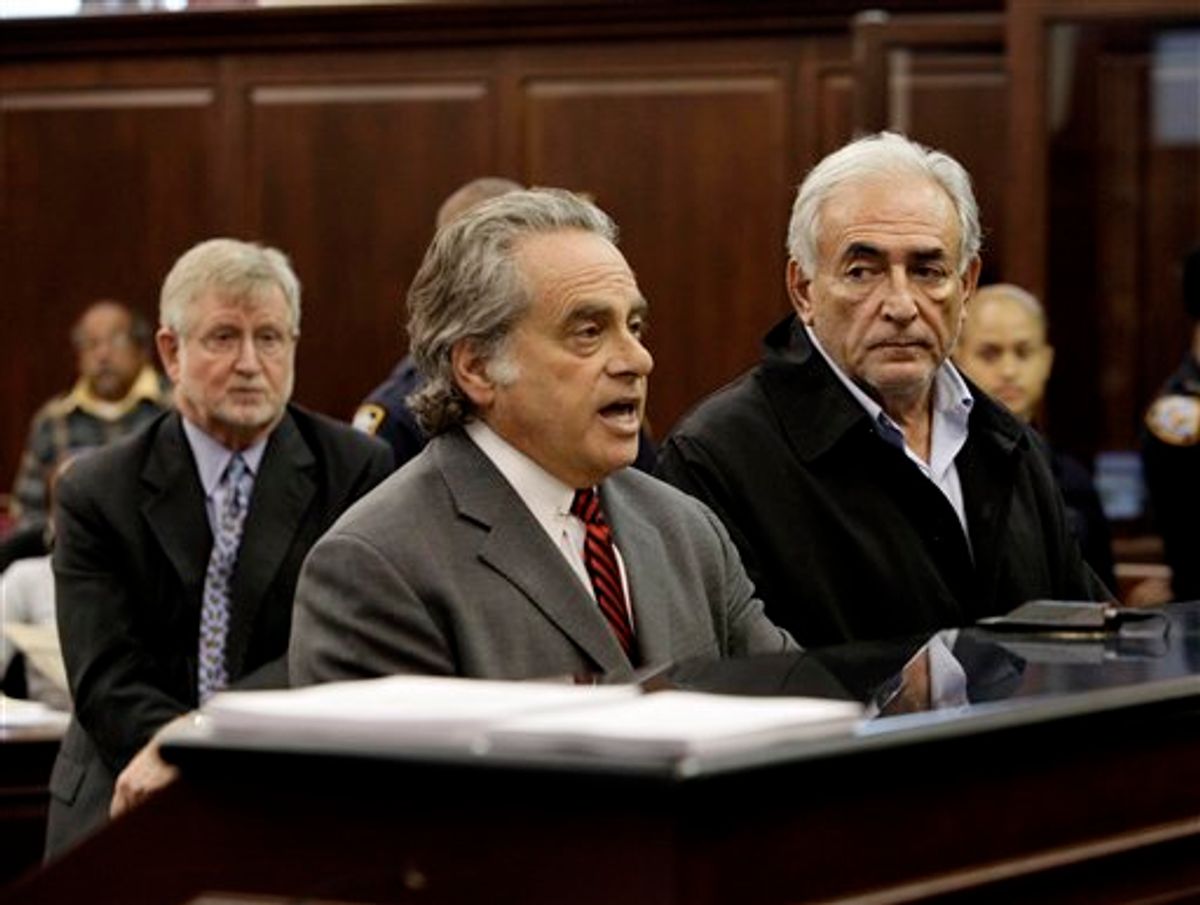 Dominique Strauss-Kahn, right, head of the International Monetary Fund listens to his attorney Benjamin Brafman, center, during arraignment proceedings Monday, May 16, 2011, in Manhattan Criminal Court, on charges for the alleged attack on a maid who went into his penthouse suite at a hotel near Times Square to clean it.  At left is his other attorney William Taylor. (AP Photo/Richard Drew, Pool) (AP)
