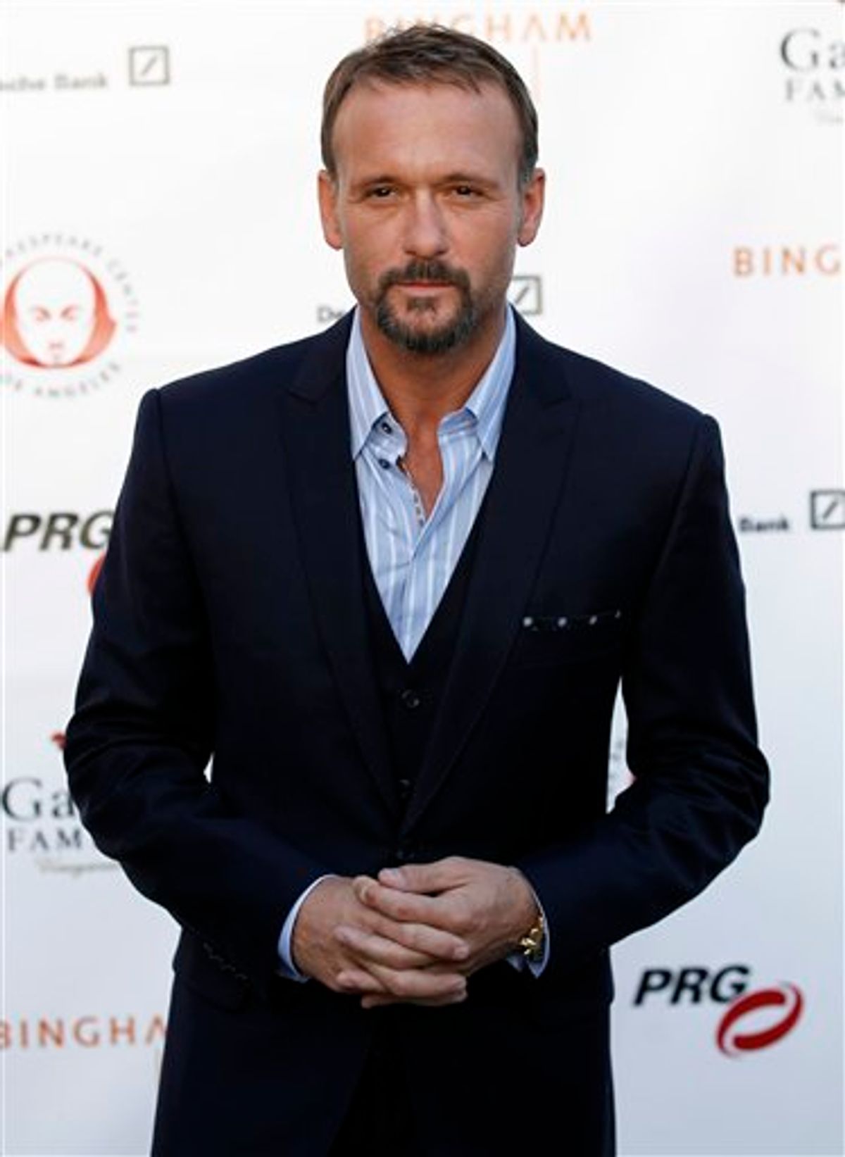 FILE - In this May 9, 2011 file photo, actor and musician Tim McGraw arrives at The Shakespeare Center of Los Angeles' 21st Annual Simply Shakespeare Fundraiser in Los Angeles.  Curb Records  has filed a breach-of-contract lawsuit against McGraw, claiming the country superstar failed to provide a fifth and final album under their deal that met contractual obligations by an April deadline.   (AP Photo/Matt Sayles, file) (AP)