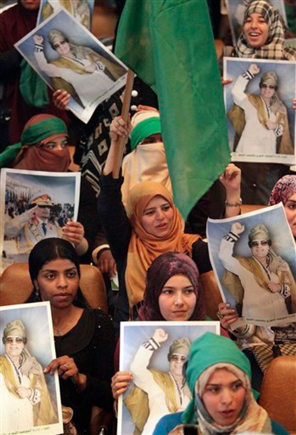 In this image taken during a trip organized by Libyan authorities, students hold portraits of Libyan leader Moammar Gadhafi during a meeting at  the Al Fateh University in Tripoli, Libya, celebrating Student Day,  Thursday, April 7, 2011. (AP Photo/Pier Paolo Cito) (AP)