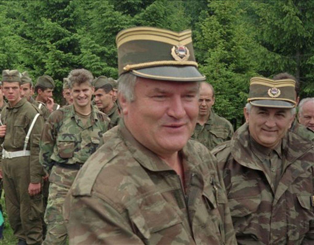 FILE In this June 28, 1996 file photo Bosnian Serb military commander General Ratko Mladic, center, smiles as he visits troops to mark both the fourth anniversary of the founding of his Bosnian Serb army and St. Vitus' Day, the anniversary of the Serb defeat by the Turks at Kosovo in 1389, near the village of Han Pijesak, some 40 miles east of Sarajevo. Belgrade media reports Thursday May 26, 2011 that a man suspected to be Europe's most wanted war crimes fugitive Ratko Mladic has been arrested in Serbia. Serbia state TV said a man who identified himself as Milorad Komadic when he was arrested Thursday is the wartime Bosnian Serb army commander. It gave no other details. (AP Photo) (AP)
