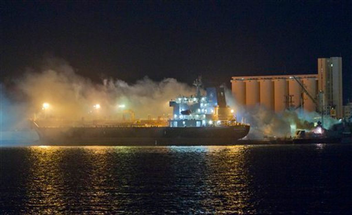 Smoke rises from a ship that was hit in an airstrike, at Tripoli sea port, Libya, early Friday, May 20, 2011. (AP Photo/Darko Bandic) (AP)