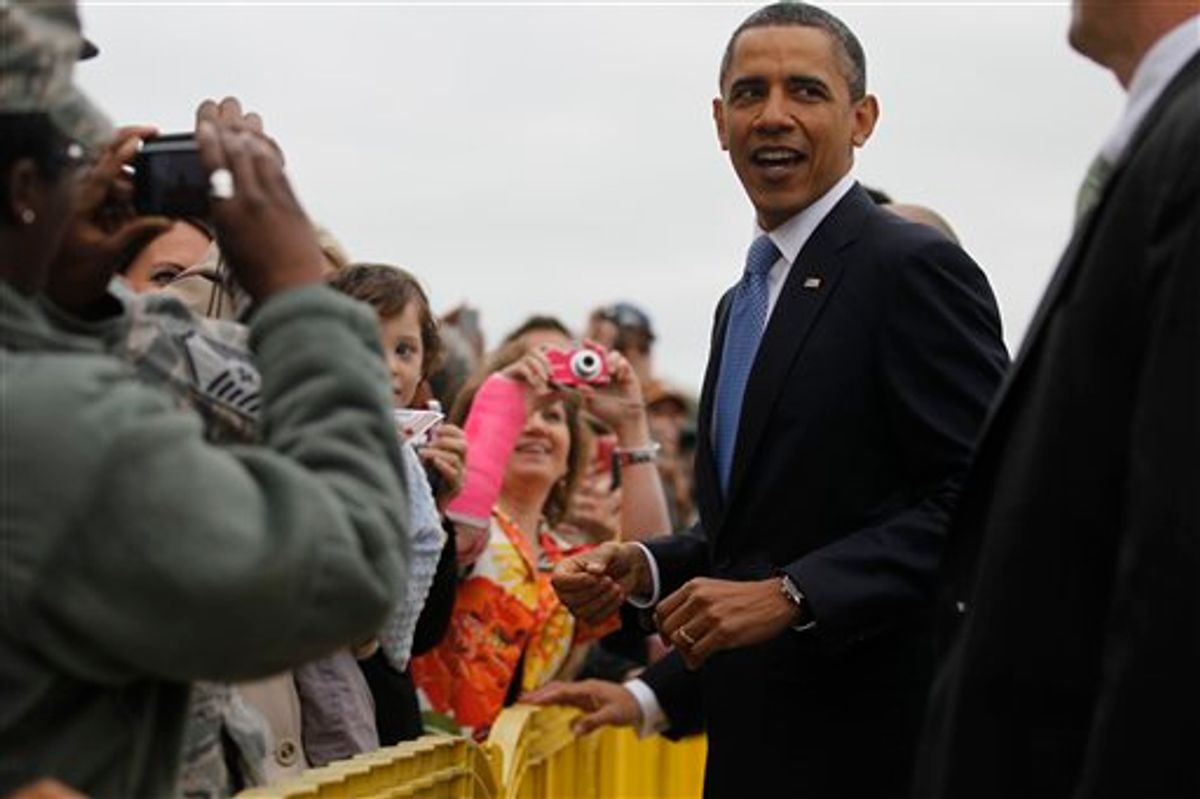 President Barack Obama greets well wishers upon arrival in Memphis, Tenn., Monday, May 16, 2011, where he will meet privately with families affected by flooding, and deliver the commencement address at Booker T. Washington High School. (AP Photo/Charles Dharapak) (AP)