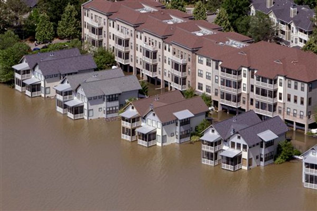 Homes on Mud Island sit in floodwater Tuesday, May 10, 2011, in Memphis, Tenn. The Mississippi River crested in Memphis at nearly 48 feet on Tuesday, falling short of its all-time record but still soaking low-lying areas with enough water to require a massive cleanup. (AP Photo/Jeff Roberson) (AP)