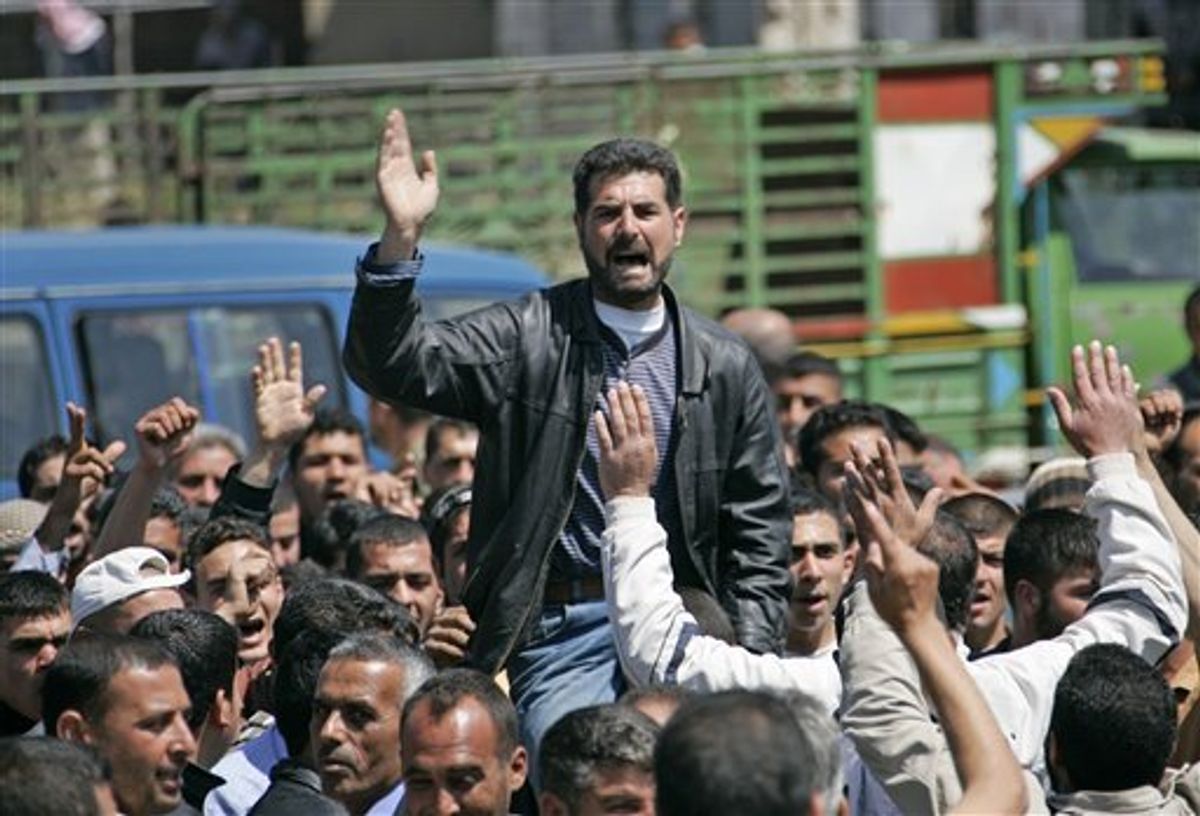 ** CORRECTS SPELLING OF LEBANESE  ** Syrian citizens who fled from violence from the western Syrian villages along the Lebanese-Syrian border, protest as they shout slogans against Bashar Assad and his regime, in the Wadi Khaled area, about one kilometer (0.6 miles) from the Lebanon-Syria border, north Lebanon, on Monday May 16, 2011. Carrying mattresses and bags of clothing, Syrians fleeing their homeland described a "catastrophic" scene Monday in a besieged border town that has been largely sealed off as the army tries to crush a two-month uprising. (AP Photo) (AP)