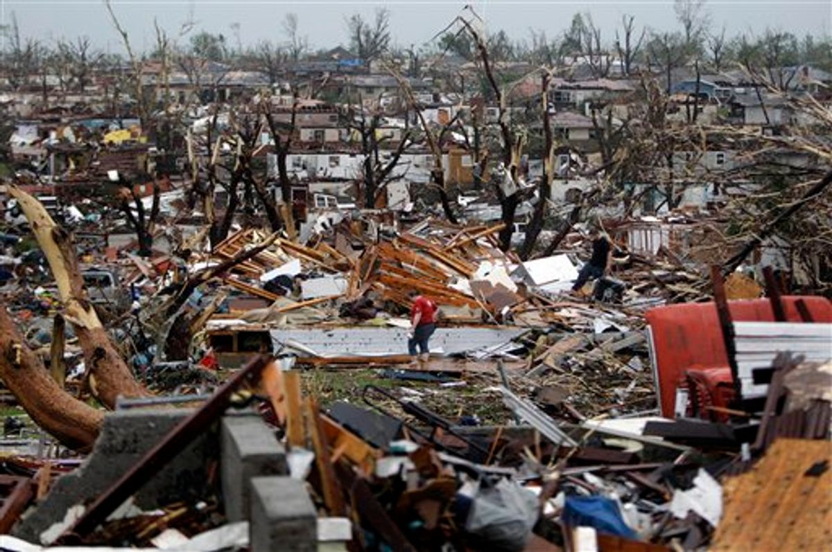 Meghan Miller stands in the middle of a destroyed neighborhood as she checks on her sister-in-law's home Monday, May 23, 2011, in Joplin , Mo. A large tornado moved through much of the city Sunday, damaging a hospital and hundreds of homes and businesses. (AP Photo/Jeff Roberson) (AP)
