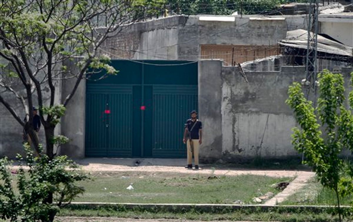 Pakistani police officers stand guard at the main gate of a house where al-Qaida leader Osama bin Laden was caught and killed in Abbottabad, Pakistan on Wednesday, May 4, 2011. The residents of Abbottabad, Pakistan, were still confused and suspicious on Wednesday about the killing of Osama bin Laden, which took place in their midst before dawn on Monday. (AP Photo/Anjum Naveed) (AP)