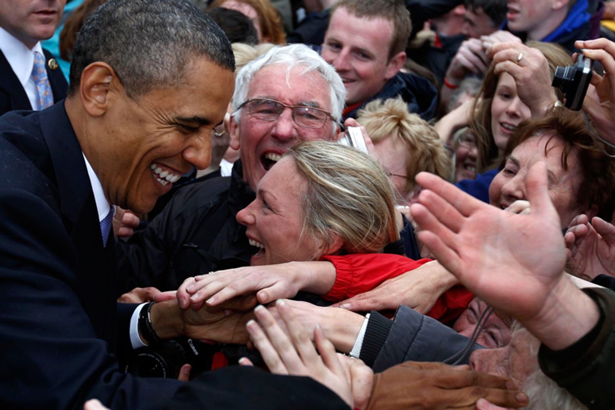 President Obama smiles as he shakes hands with a crowd of local residents in Moneygall.  