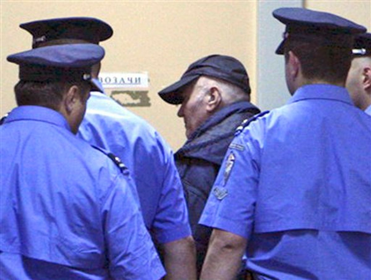 In this handout image released by the Serbian government Thursday, May 26, 2011,  Ratko Mladic  enters court in Belgrade, Thursday, May 26, 2011.  Ratko Mladic, in baseball cap,  the ruthless Bosnian Serb military leader charged with orchestrating Europe's worst massacre of civilians since World War II, was arrested before dawn at a relative's home in a tiny Serbian village on Thursday after a 16-year hunt for the architect of what a war-crimes judge called "scenes from hell."  (AP Photo / Serbian Government, HANDOUT) (AP)