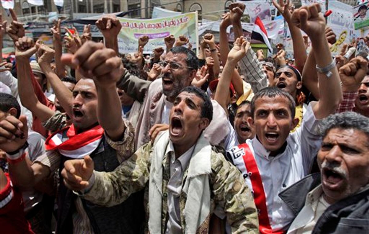 Anti-government protestors, shout slogans during a demonstration demanding the resignation of Yemeni President Ali Abdullah Saleh, in Sanaa, Yemen, Monday, May 23, 2011.   (AP Photo/Hani Mohammed) (AP)