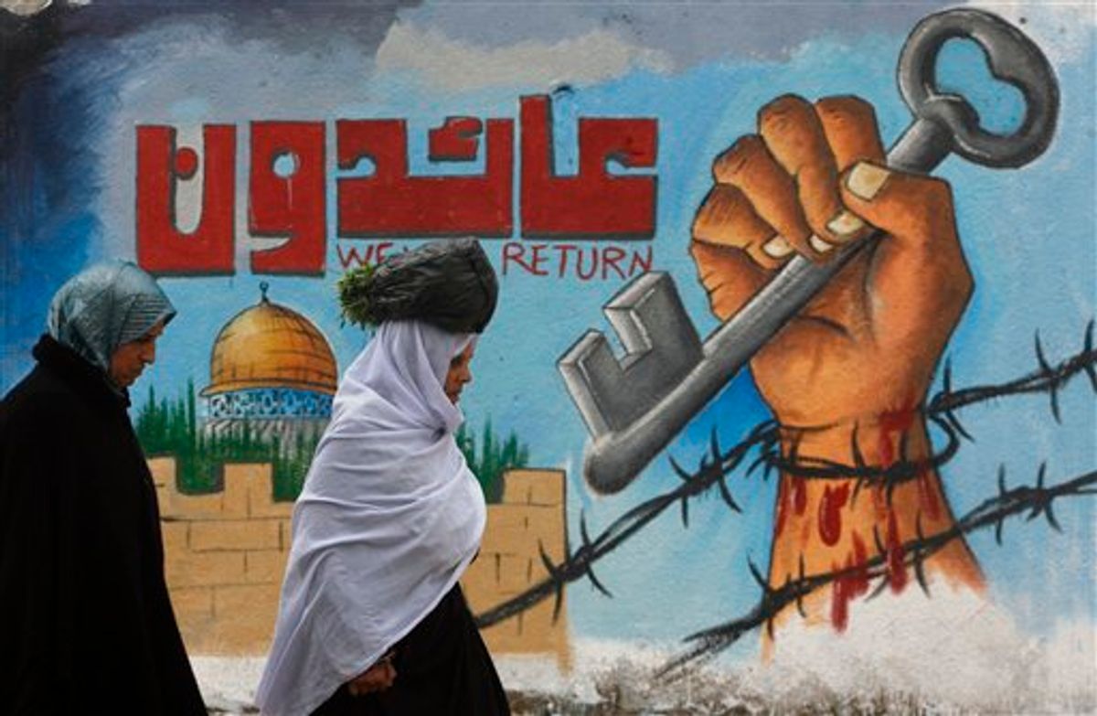 Palestinians walk past a painted wall during a rally marking the upcoming 63rd anniversary of the Nakba, or catastrophe, the Arabic term used to describe the uprooting of hundreds of thousands of Palestinians with the 1948 creation of the state of Israel, in Rafah refugee camp, southern Gaza Strip, Saturday, May 14, 2011.  Graffiti painting symbolically depicts the loss of the homes of Palestinians in 1948. ( AP Photo/ Eyad Baba ) (AP)