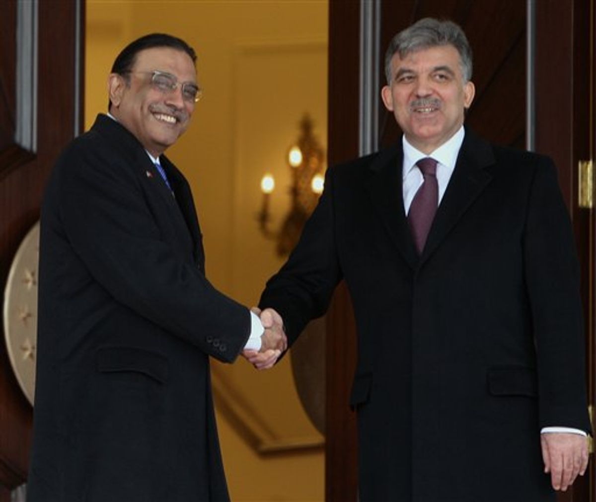 Pakistan's President Asif Ali Zardari, left, and his Turkish counterpart Abdullah Gul shake hands as they pose for cameras during a ceremony at the Cankaya presidential palace in Ankara, Turkey, Wednesday, April 13, 2011. Zardari is in Turkey for a four-day state visit.(AP Photo/Burhan Ozbilici) (AP)