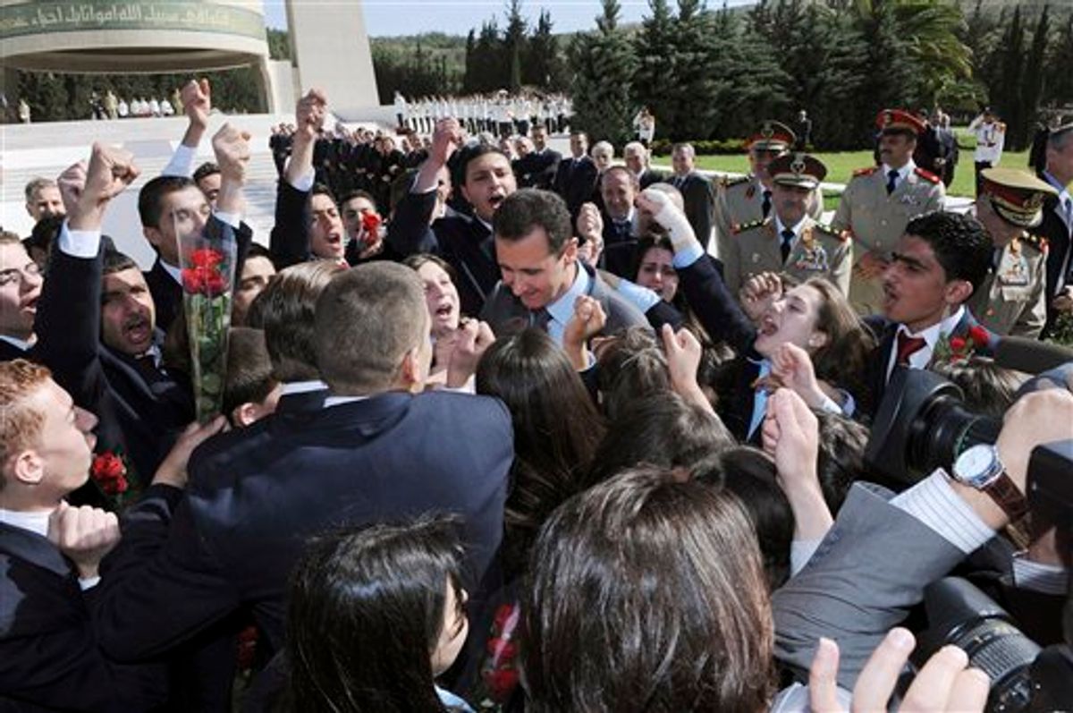 In this photo released by the Syrian official news agency SANA, Syrian students shout supportive slogans to Syrian President Bashar Assad, center, as he arrives to lay a wreath at the tomb of the unknown soldier during Martyrs day in Kasiyoun mountain in Damascus, Syria, Friday, May 6, 2011. Syrian activists say security forces are taking strict measures around the country as anti-regime protesters prepare for a new day of demonstrations. (AP Photo/SANA) EDITORIAL USE ONLY  (AP)