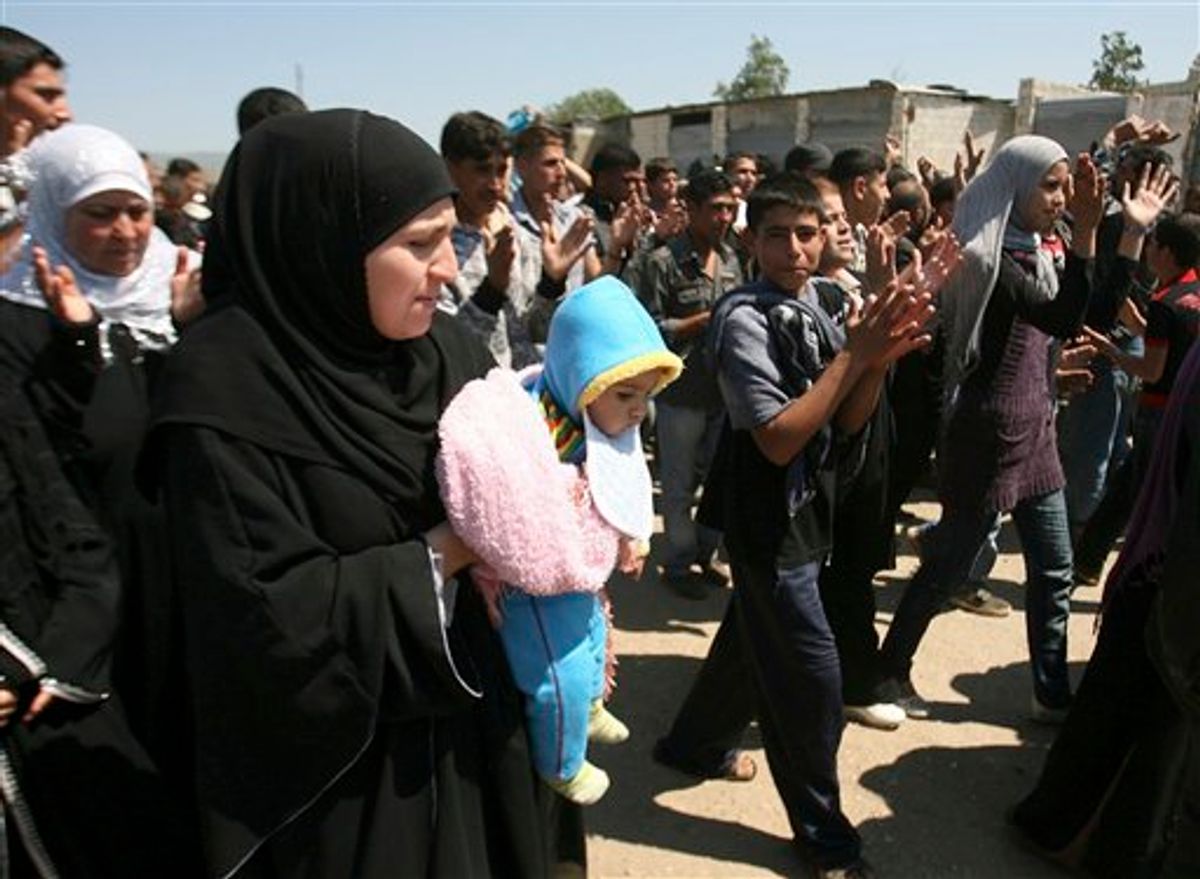 Syrian citizens who fled from violence from the western Syrian villages along the Lebanese-Syrian border, protest as they shout slogans against Bashar Assad and his regime, in the Wadi Khaled area, about one kilometer (0.6 miles) from the Lebanon-Syria border, north Lebanon, on Monday May 16, 2011. Carrying mattresses and bags of clothing, Syrians fleeing their homeland described a "catastrophic" scene Monday in a besieged border town that has been largely sealed off as the army tries to crush a two-month uprising. (AP Photo) (AP)