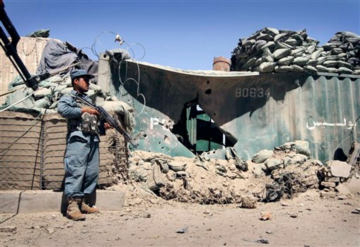 An Afghan policeman stands guard at the scene of an explosion in Kandahar south of Kabul, Afghanistan on Sunday, May 22, 2011. In Kandahar, two police officers suffered injuries Sunday when a motorcycle laden with explosives detonated as they tried to disarm it, the ministry said. (AP Photo/Allauddin Khan) (AP)