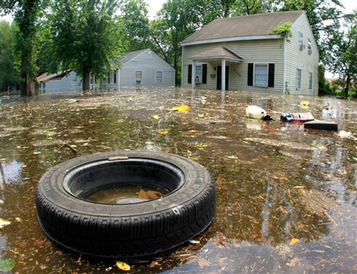 Trash floats by flooded homes on Monday, May 9, 2011, in Memphis, Tenn. The swollen Mississippi River could crest as early as Monday night. (AP Photo/Mark Humphrey) (AP)