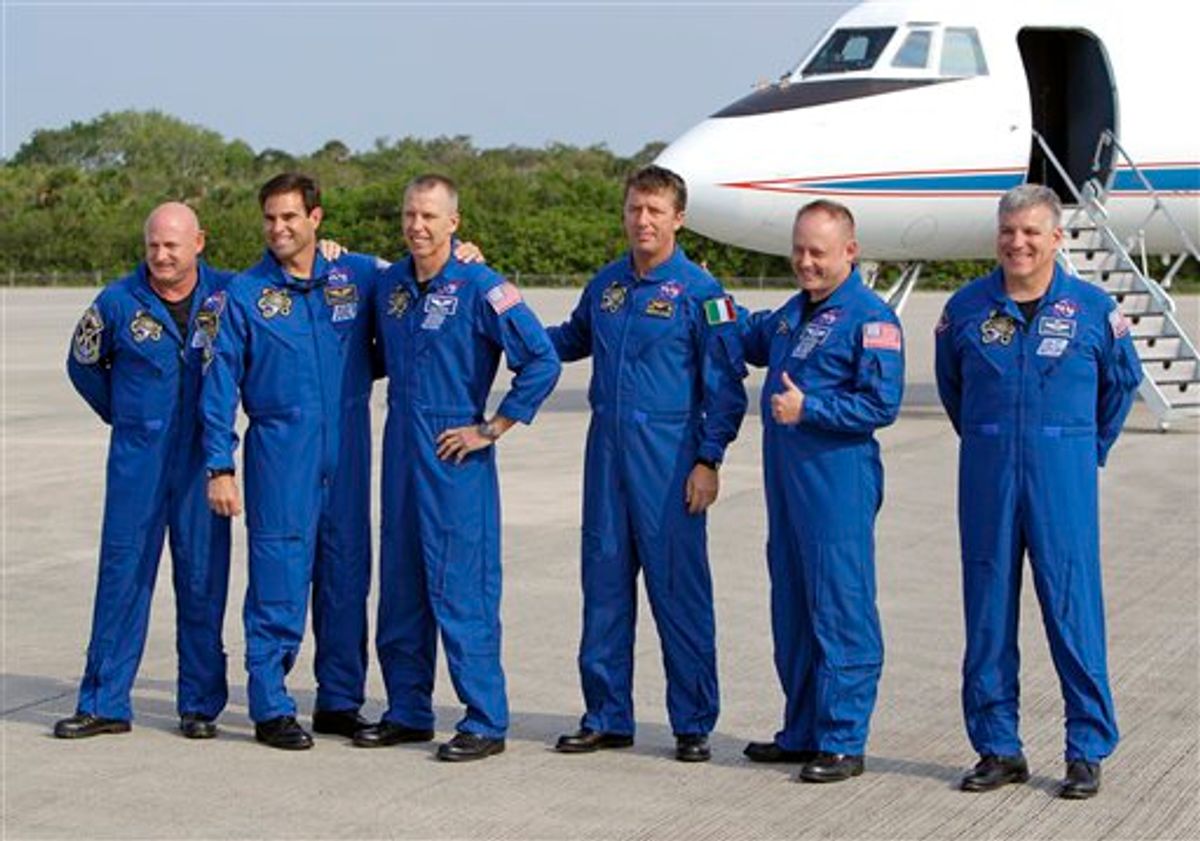 The astronauts of space shuttle Endeavour, from left, commander Mark Kelly, Canadian born U.S. astronaut Greg Chamitoff, mission specialist Drew Feustel, European Space Agency astronaut Roberto Vittori, of Italy, mission specialist Mike Fincke and British born U.S. astronaut, pilot Greg Johnson, gather for a photo after arriving at the Kennedy Space Center in Cape Canaveral, Fla., Thursday, May 12, 2011. The astronauts for NASA's next-to-last space shuttle flight returned to Florida on Thursday for another try at launching to the International Space Station. (AP Photo/John Raoux) (AP)