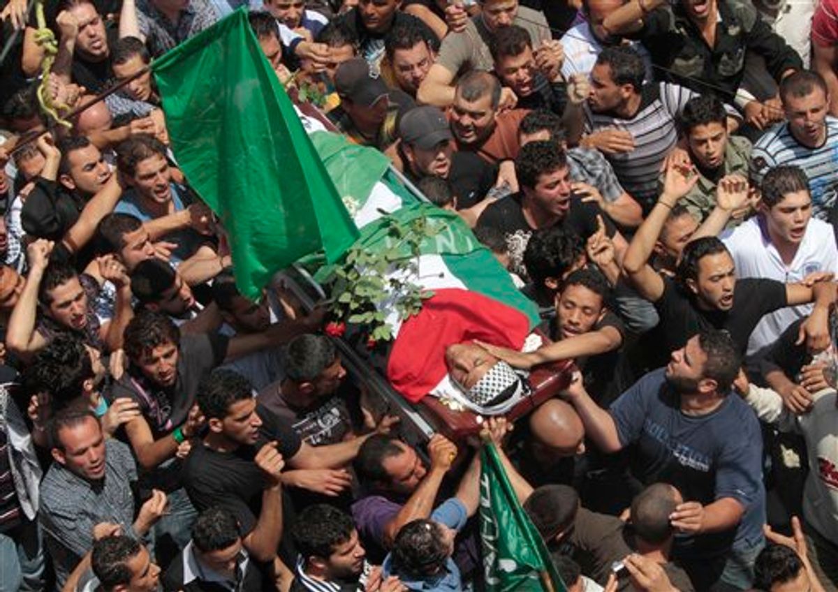 Palestinian mourners carry the body of a Palestinian man who killed when Israeli soldiers opened fire on Sunday at protesters who approached the northen Israeli border with Lebanon, during a funeral procession at Ein el-Hilweh Palestinian refugee camp, in the southern port city of Sidon, southern Lebanon, on Monday May 16, 2011. Israeli troops clashed with Arab protesters along three hostile borders on Sunday, leaving as many as 12 people dead and dozens wounded in an unprecedented wave of violence marking the anniversary of the mass displacement of Palestinians surrounding Israel's establishment in 1948. (AP Photo/Mohammed Zaatari) (AP)