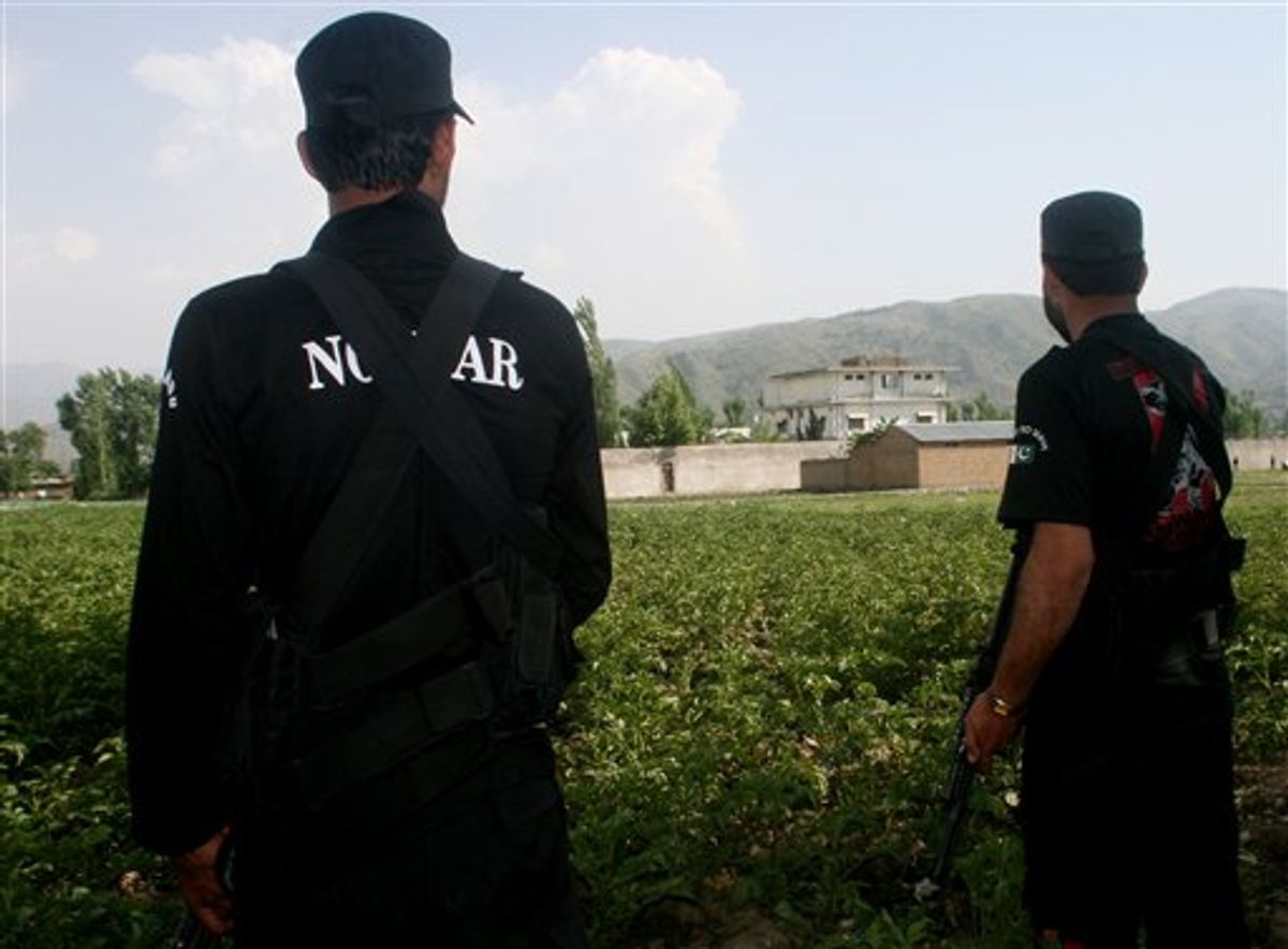 Pakistani security officers stand guard near the perimeter of the compound of al-Qaida leader Osama bin Laden in Abbottabad, Pakistan, Wednesday, May 4, 2011.  Many of the residents of Abbottabad seem to be confused and suspicious about the killing of Osama bin Laden, which took place in their midst before dawn on Monday, even as the U.S. White House has struggled to communicate its account of the audacious raid that killed Osama bin Laden for both a jubilant American public and a skeptical Muslim world. (AP Photo/Aqeel Ahmed) (AP)