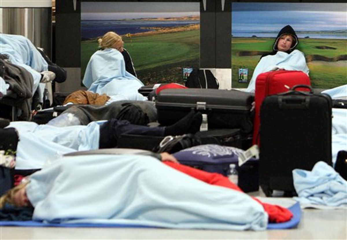Passengers rest on the floor as their flights have been canceled at Edinburgh Airport in Edinburgh, Scotland Tuesday, May 24, 2011. A dense ash cloud from an Icelandic volcano blew toward Scotland, causing airlines to cancel Tuesday flights and raising fears of a repeat of last year's huge travel disruptions in Europe that stranded millions of passengers. (AP Photo/Scott Heppell) (AP)