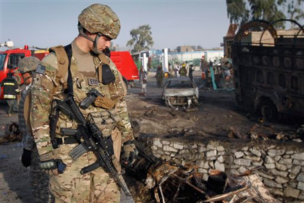 An unidentified U.S. soldier is seen at the scene of a suicide attack in Jalalabad, Afghanistan on Wednesday, May 18, 2011