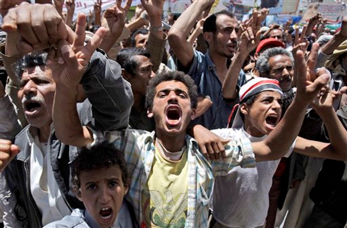 Anti-government protestors react during a demonstration demanding the resignation of Yemeni President Ali Abdullah Saleh, in Sanaa, Yemen, Tuesday, May 24, 2011. Fighters for Yemen's largest tribe sealed off key government buildings and barricaded streets in the heart of the capital Tuesday as the revolt against President Ali Abdullah Saleh sharply escalated after militiamen turned their guns against government forces. (AP Photo/Hani Mohammed) (AP)