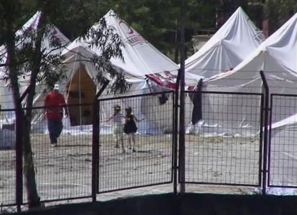 This image taken from video released by Anatolia Agency shows two Syrian refugee children playing outside tents in a camp built to accommodate 5,000 people in the town of Yayladagi, Hatay province, Turkey near the Syrian border Thursday June 9, 2011. About 1,000 Syrians fleeing violence crossed into Turkey overnight, raising the total number of refugees in the country to 1,600. Hundreds of Syrians fled to Turkey on Thursday as elite Syrian troops moved to encircle a restive town ahead of a possible assault, sharply escalating the upheaval that threatens the 40-year regime led by President Bashar Assad.   (AP Photo/Anatolia Agency via APTN) TURKEY OUT, TV OUT (AP)