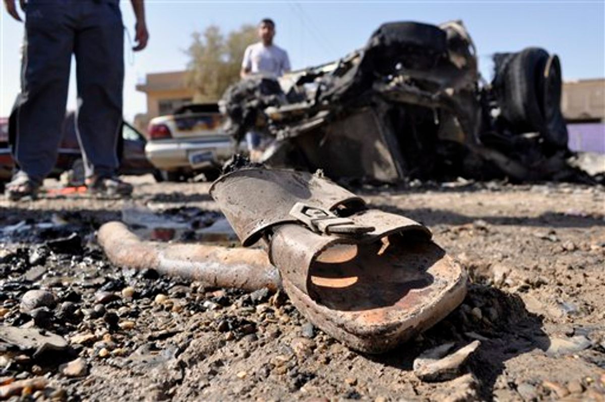 A discarded sandal is seen amid debris and destroyed vehicles the morning after four blasts killed several people in Ramadi, 70 miles (115 kilometers) west of Baghdad, Iraq, Friday, June 3, 2011. The blasts in what was the heartland of the al-Qaida-led insurgency are a reminder of the danger still facing Iraq, as it prepares for the departure of the remaining U.S. troops by the end of this year.(AP Photo) (AP)