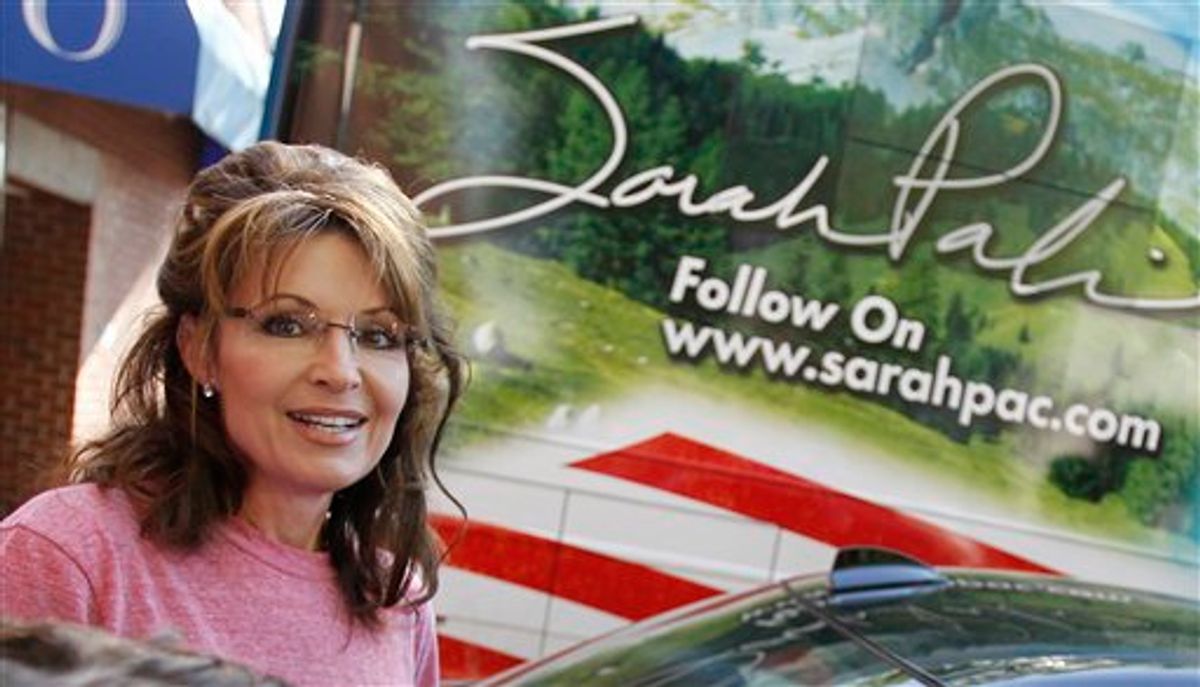 Former Alaska Gov. Sarah Palin stands near her tour bus outside a hotel in Boston, Thursday, June 2, 2011. (AP Photo/Steven Senne) (AP)