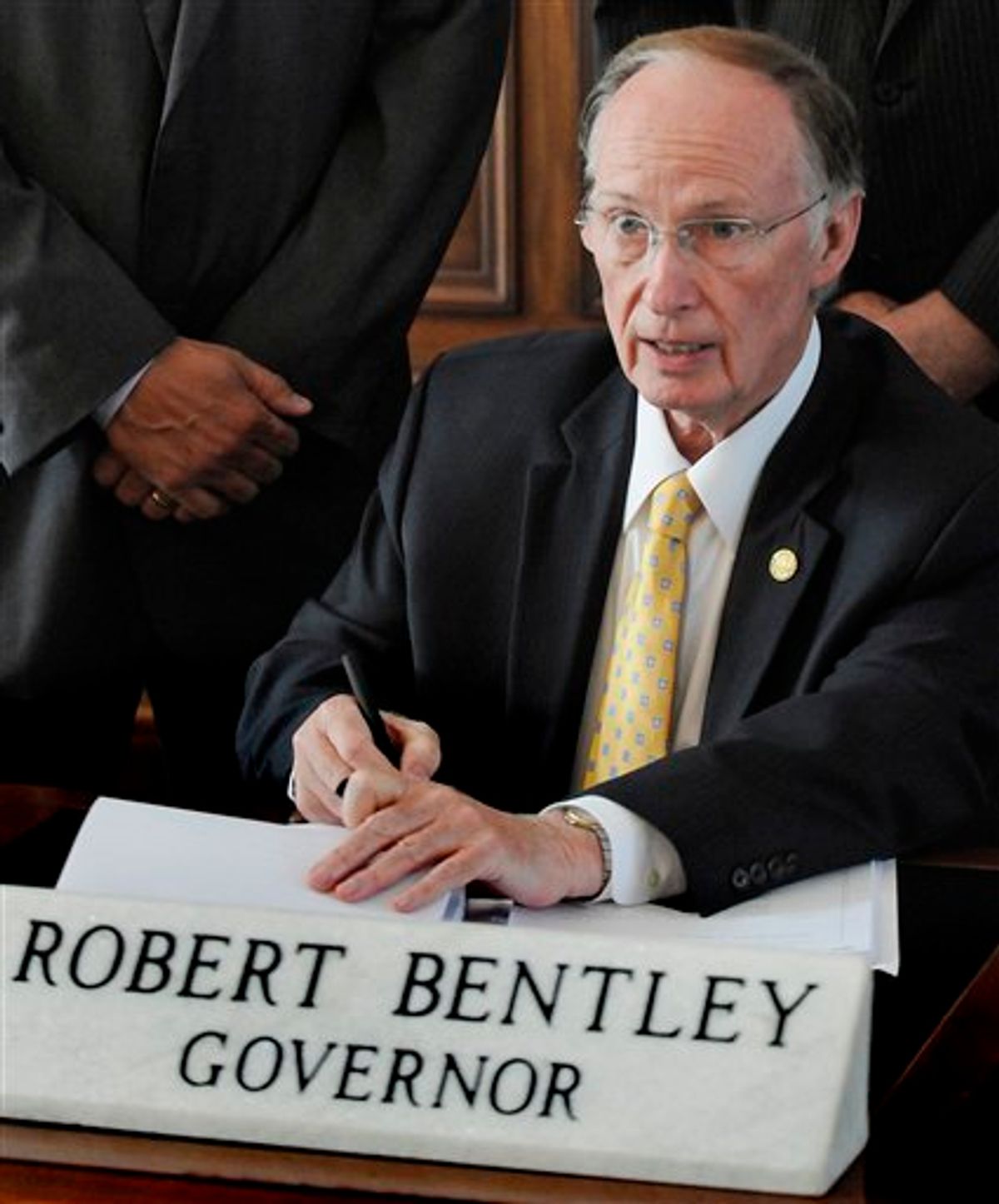 Alabama Gov. Robert Bentley signs into law, what critics and supporters are calling the strongest bill in the nation cracking down on illegal immigration, on Thursday, June 9, 2011 at the state Capitol in Montgomery, Ala. The bill  allows police to arrest anyone suspected of being an illegal immigrant if they're stopped for any other reason. It also requires public schools to determine students' immigration status and makes it a crime to knowingly give an illegal immigrant a ride. (AP Photo/Montgomery Advertiser, Mickey Welsh) (AP)
