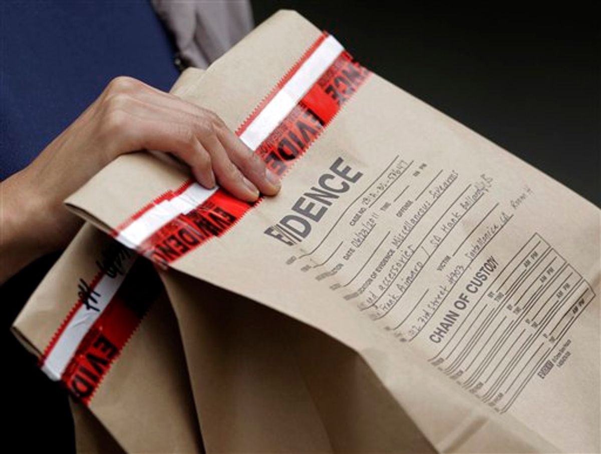 An FBI agent holds an evidence bag outside an apartment complex where fugitive crime boss James "Whitey" Bulger and his longtime companion Catherine Greig were arrested in Santa Monica, Calif., Thursday, June 23, 2011. The Boston mob boss was captured near Los Angeles after 16 years on the run that embarrassed the FBI and exposed the bureau's corrupt relationship with its underworld informants. (AP Photo/Jae C. Hong)  (AP)