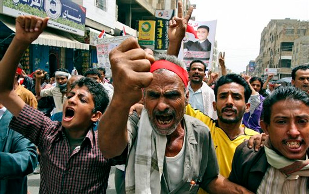 Anti-government protestors shout slogans during a demonstration demanding the resignation of Yemeni President Ali Abdullah Saleh, in Taiz, Yemen, Sunday, June 19, 2011. (AP Photo/Anees Mahyoub) (AP)