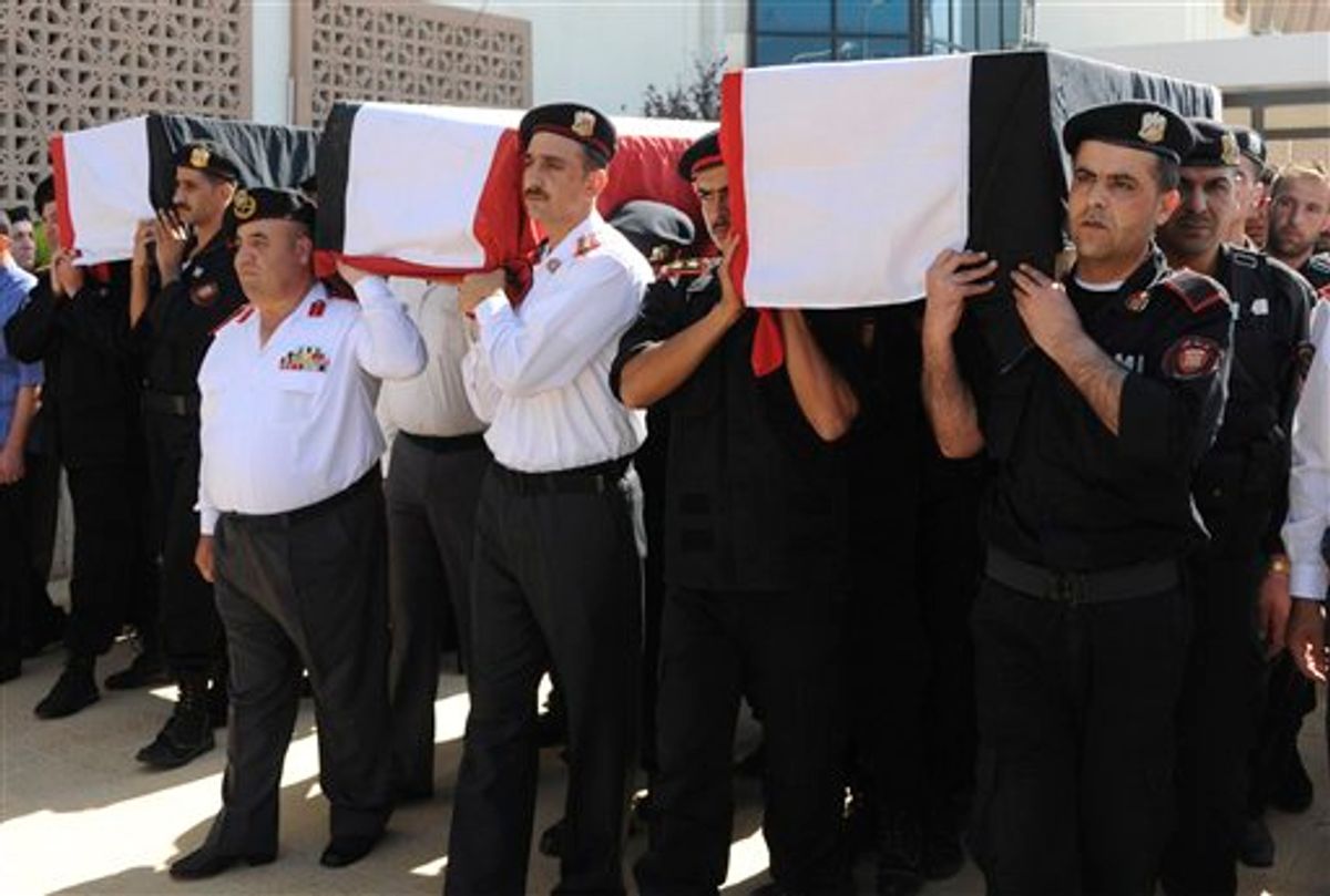 In this photo released by the Syrian official news agency SANA and according to them, Syrian policemen carry the coffins of their comrades who were killed in recent violence in the country, during their funeral procession at the Police Hospital in Damascus, Syria on Tuesday, June 7, 2011. Residents fled the northern region of Jisr al-Shughour on Tuesday where authorities said weekend clashes between armed men and government troops killed 120 security forces, fearing retaliation from a regime known for ruthlessly crushing dissent. (AP Photo/SANA) EDITORIAL USE ONLY (AP)