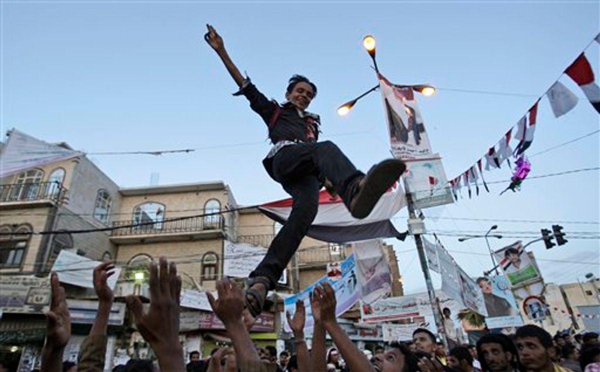 Anit-government protestors reach to catch a youth, after throwing him in to the air while celebrating President Ali Abdullah Saleh's departure to Saudi Arabia, in Sanaa, Yemen, Monday, June 6, 2011. A cease-fire in Yemen's capital was at risk of unraveling Monday as regime supporters opened fire on opposition fighters in renewed clashes that killed at least six. The violence raises fears over the potentially explosive situation after the wounded President Ali Abdullah Saleh left the country, creating a deep power vacuum. (AP Photo/Hani Mohammedi) (AP)