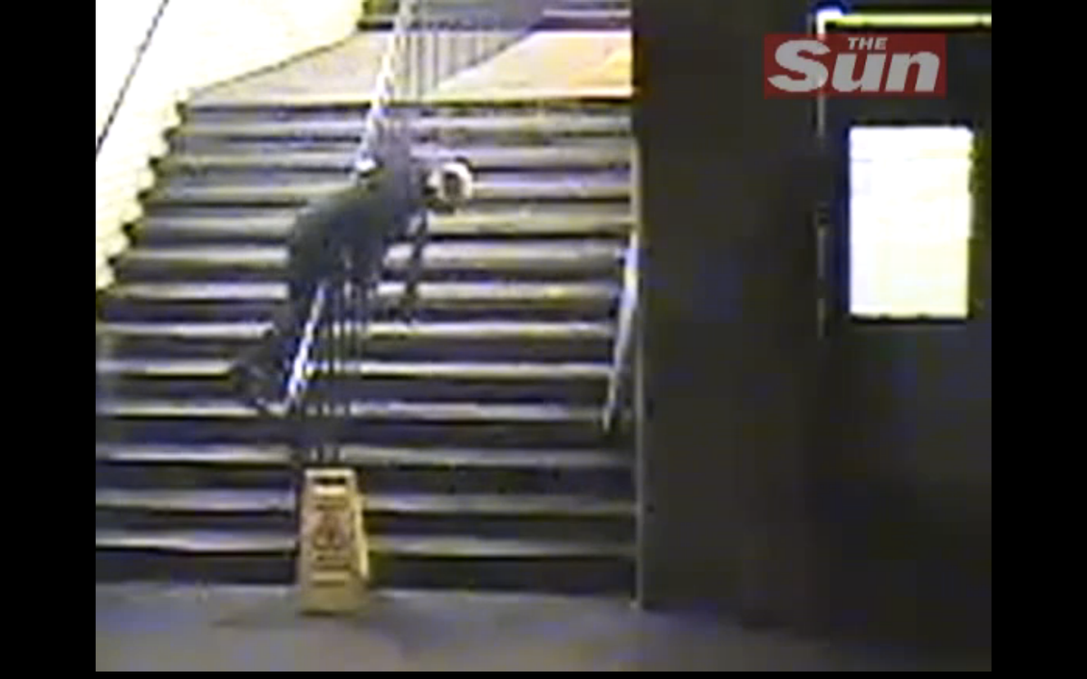 A drunk man is caught flipping over a banister closed-circuit television in London.