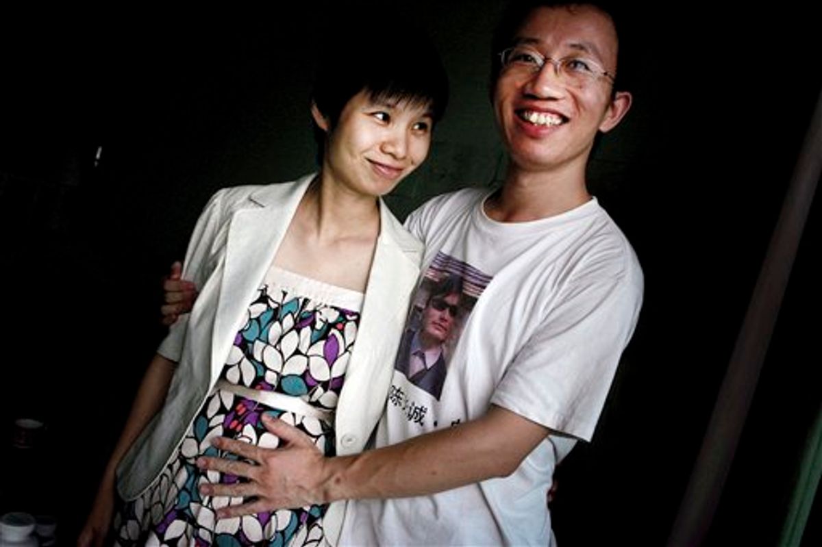 FILE - In this July 6, 2007 file photo, Hu Jia, right, and Zeng Jinyan, husband-and-wife activists, pose for a picture at their home in Beijing. Zeng said she visited Hu, who was jailed for sedition more than three years ago, in prison June 20, 2011. Jia was released Sunday, his wife said. (AP Photo/Elizabeth Dalziel, File) (AP)