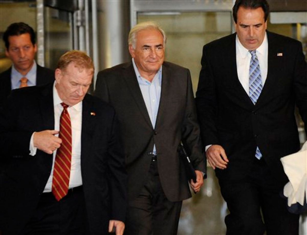 Dominique Strauss-Kahn, center, is led from 71 Broadway in Manhattan's financial district where the former International Monetary Fund leader was staying following his release on bail, Wednesday, May 25, 2011, in New York. (AP Photo/Louis Lanzano) (AP)