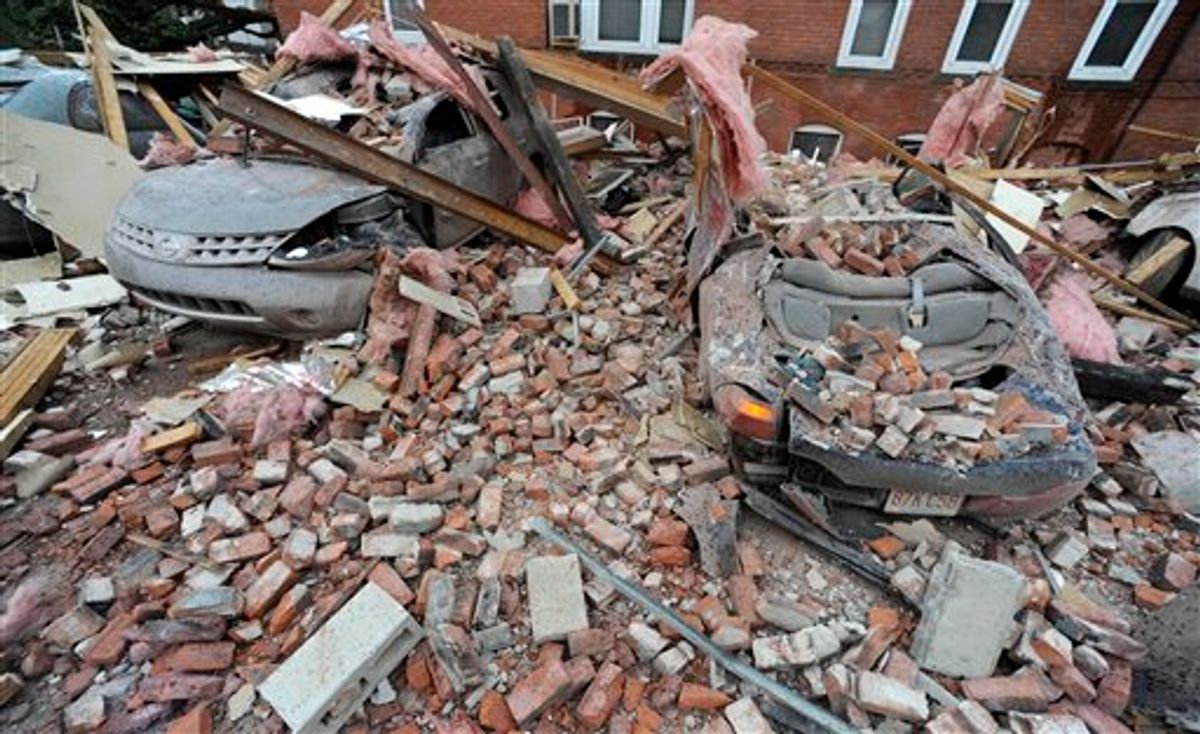 Bricks and debris that fell from a building lay on top of cars after a report of a tornado in Springfield, Mass., Wednesday, June 1, 2011. An apparent tornado struck downtown Springfield, one of Massachusetts' largest cities, scattering debris, toppling trees, and frightening workers and residents. (AP Photo/Jessica Hill) (AP)