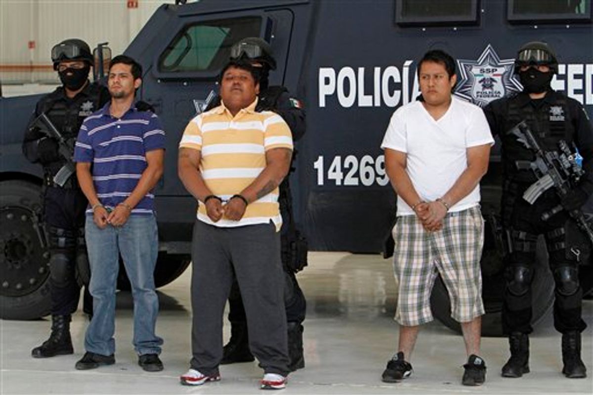 Federal police officers escort Julio de Jesus Radilla Hernandez, aka "El Negro", center, Jose Luis Luquin Delgado, aka "El Jabon" , left, and  Valentin Ortiz Lopez, as they are presented to the press at the federal police headquarters in Mexico City, Wednesday, May 25, 2011. Mexico's federal police said Radilla Hernandez is allegedly responsible for ordering the March 27 murder of Juan Francisco Sicilia, son of Mexican poet Javier Sicilia and six other people. Luquin Delgado and Ortiz Lopez are also involved in the crime. (AP Photo/Marco Ugarte)  (AP)