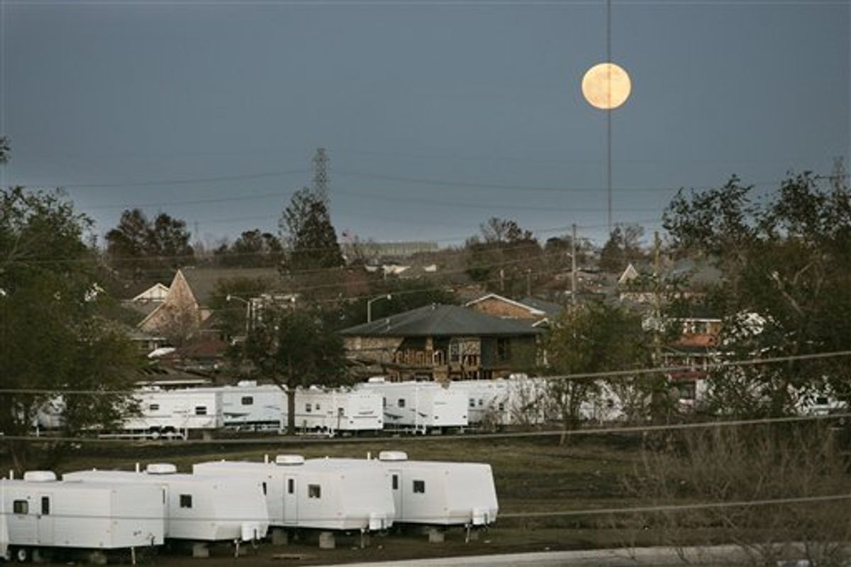 FILE -In this Dec. 15, 2005 file photo, the moon rises over FEMA trailers and damaged homes in St. Bernard Parish, La. Nearly six years have passed since Hurricane Katrina drowned this city in misery, but many residents haven't forgiven the Federal Emergency Management Agency for its sluggish response to the storm. Now another delayed reaction by FEMA _ a stop-and-start push to recoup millions of dollars in disaster aid _ is reminding storm victims why they often cursed the agency's name.( AP Photo/Gerald Herbert, File) (AP)
