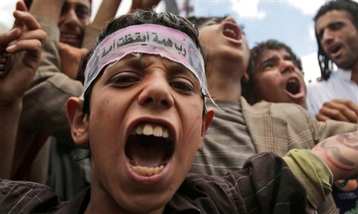 A Yemeni boy, shouts slogans along with anti-government protestors during a demonstration demanding the resignation of Yemeni President Ali Abdullah Saleh, in Sanaa, Yemen, Thursday, June 2, 2011. Street battles raged Thursday between the army and opposition tribesmen in the capital Sanaa and dozens of people on both sides were killed and wounded. Elsewhere a thousands-strong force of tribal fighters fought to break through government lines on the northern outskirts of the city. Arabic reads on the boy's headband, " Little efforts woke up a nation".  (AP Photo/Hani Mohammed) (AP)