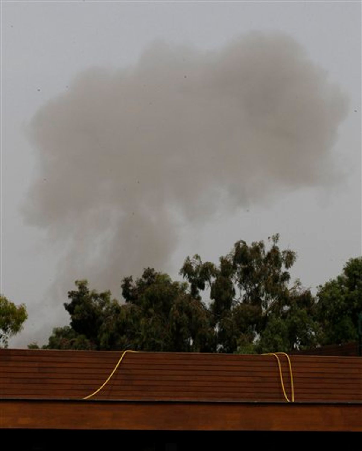 A smoke plume rises into the sky over Tripoli, Libya, on Tuesday, June 7, 2011 following an airstrike. Low-flying NATO military craft have struck seven times in loud, banging succession over the Libyan capital Tripoli. The strikes occurred Tuesday morning, marking an increase in NATO pressure on the regime of Moammar Gadhafi. (AP Photo/Ivan Sekretarev) (AP)