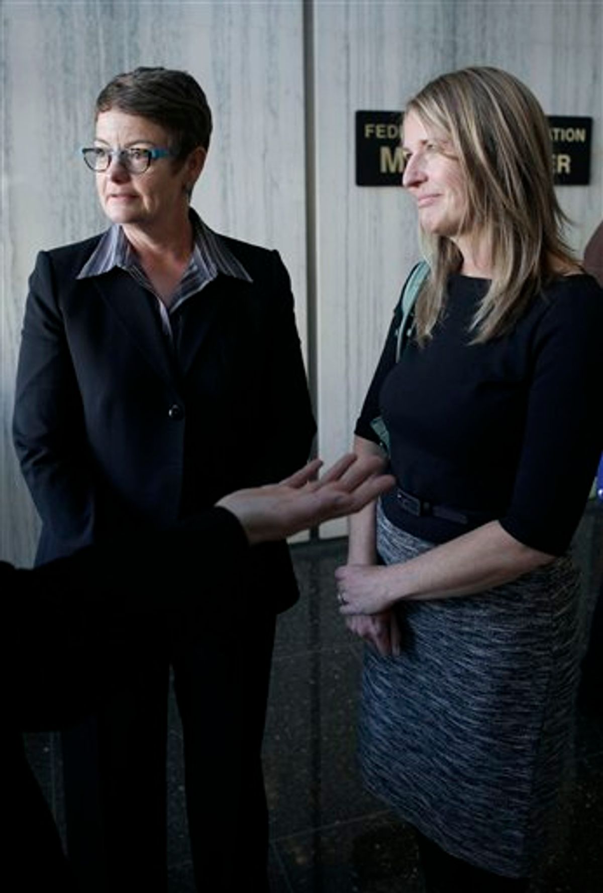 Kris Perry, left, speaks with reporters next to her partner Sandy Stier at the Phillip Burton Federal Building in San Francisco, Monday, June 13, 2011. A retired federal judge's long-term relationship with another man was the subject of an unusual and possibly unprecedented court hearing that began Monday involving California's same-sex marriage ban. Lawyers for the sponsors of the voter-approved ban asked the chief federal judge in San Francisco to vacate a decision issued by his predecessor last year that declared the same sex marriage ban an unconstitutional violation of gay Californians' civil rights. (AP Photo/Jeff Chiu) (AP)