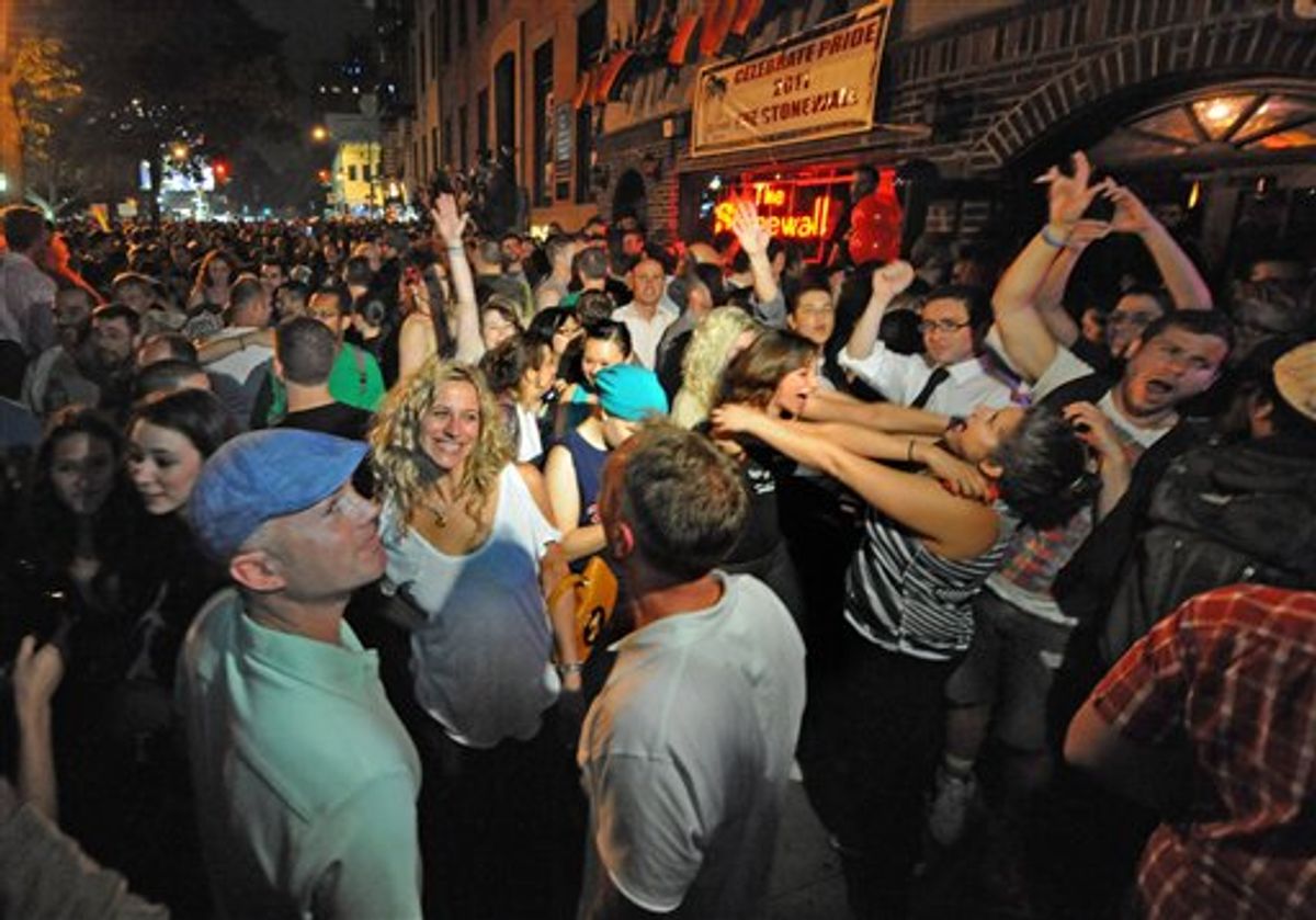 Revelers celebrate in front of the Stonewall Inn in Manhattan's west village following the passing of the same sex marriage bill by a vote of 33 to 29, Friday, June 24, 2011, in New York. Same-sex marriage is now legal in New York after Gov. Andrew Cuomo signed a bill that was narrowly passed by state lawmakers Friday, handing activists a breakthrough victory in the state where the gay rights movement was born. The gay rights movement is considered to have started with the Stonewall riots in New York City's Greenwich Village in 1969. (AP Photo/Louis Lanzano) (AP)