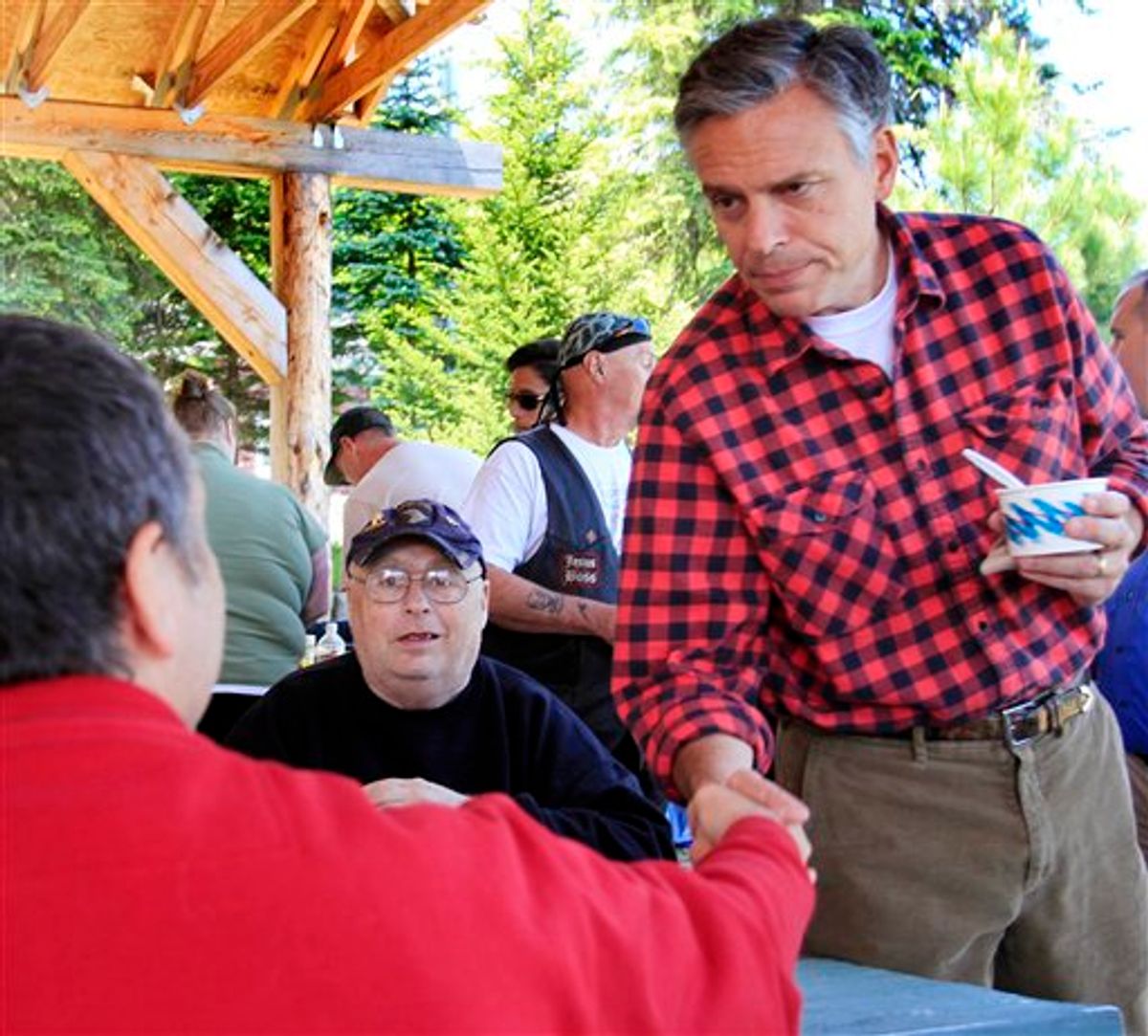 With his wife Mary Kaye at his side possible 2012 presidential hopeful, former Republican Gov. Jon Huntsman, Jr., of Utah shakes hands during a cultural festival at Heritage Park, Saturday, June 4, 2011 in Berlin, N.H. (AP Photo/Jim Cole) (AP)
