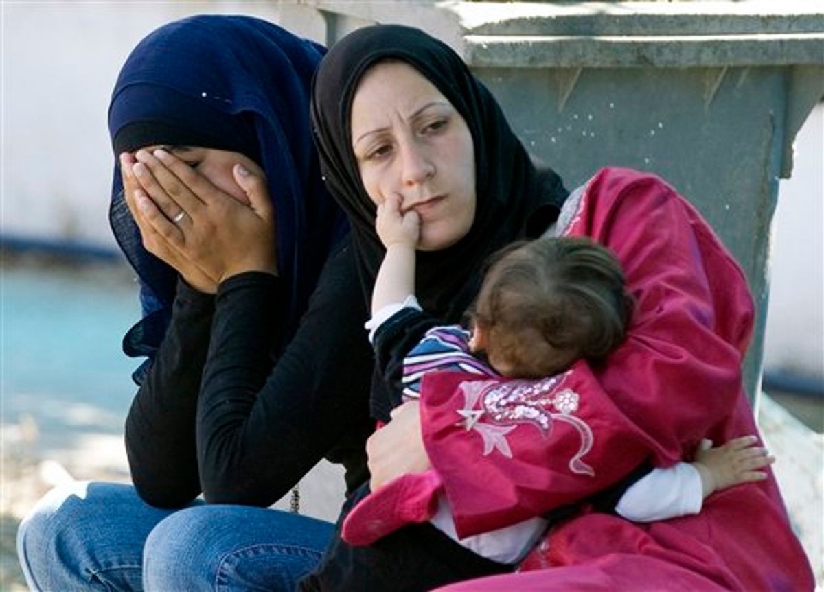 A Syrian refugee mother feeds her baby as another covers her face, in a makeshift hospital in a newly opened refugee camp in the Turkish town of Yayladagi in Hatay province, Turkey, Wednesday, June 22, 2011. The U.N. refugee agency said that 500 to 1,000 people a day have been crossing from northern Syria into Turkey since June 7, and more than 10,000 were being sheltered by Turkish authorities in four border camps(AP Photo/Burhan Ozbilici) (AP)
