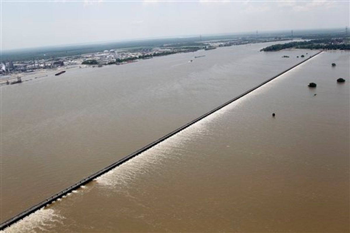 Water from the Mississippi River, left, is seen from the air as it is diverted through the floodgates of the Bonnet Carre Spillway towards Lake Pontchartrain (not pictured) in Norco, La., just upriver from New Orleans, Friday, June 3, 2011. (AP Photo/Gerald Herbert) (AP)