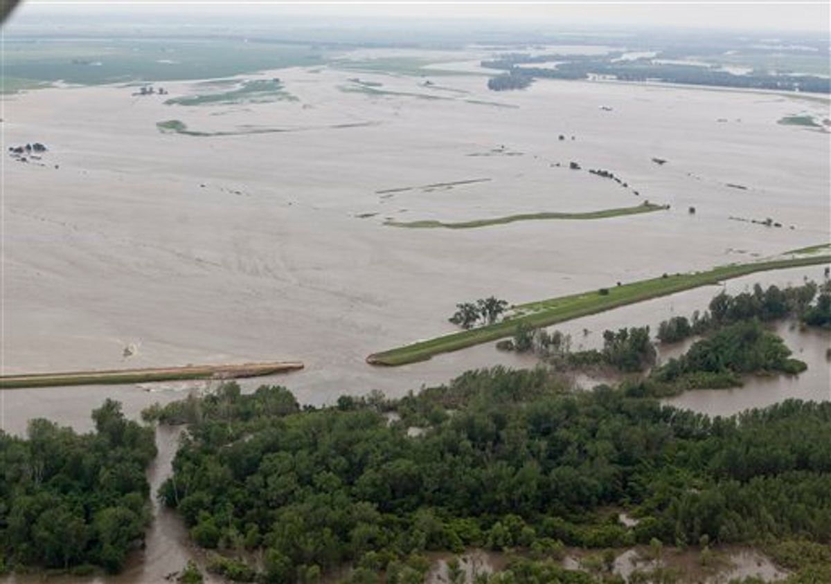 An aerial view of a ruptured levee near Hamburg, Iowa, Monday, June 13, 2011, which was letting in water from the Missouri river. The rising Missouri River has ruptured two levees in northwest Missouri, sending torrents of floodwaters over rural farmland toward the Iowa town of Hamburg and the Missouri resort town of Big Lake. (AP Photo/Nati Harnik) (AP)